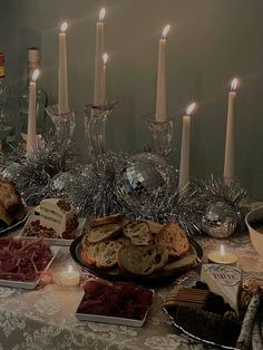 a table topped with lots of food and candles