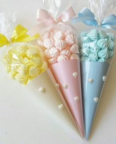 three candy cones with bows on them sitting next to each other