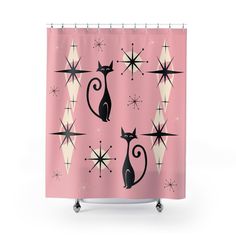 a pink shower curtain with black and white cat on it's side, surrounded by stars