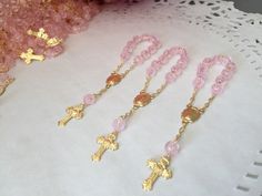 "20 Rosarios pequeñitos o decenario en color rosa., hechos a Mano con la Imagen de la virgen de Guadalupe , bañados en Oro y hechos de acrilico con figurita de rosa. Mide cerca de 10cm de largo y Las cuentitas importados son de 6 mm. 20 PINK COLOR , ACRYLIC BEADS IN SHAPE OF ROSEBUDS ON THIS MINI ROSARIES . ALL HAND MADE AND GOLD PLATED THEY MEASURE ABOUT 4\" INCHES EACH. COMVO US WITH Any QUESTIONS. Thanks!" Personalized Pink Rosary Bracelet For Baptism, Pink Spiritual Jewelry For First Communion, Pink Rosary For First Communion, Pink Rosary With Round Beads For First Communion, Handmade Pink Rosary For Baptism, Handmade Pink Rosary For First Communion, Handmade Pink Rosary With Round Beads, Handmade Pink Jewelry For Baptism, Handmade Pink Rosary With Cross