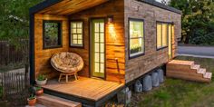 two tiny houses in the woods, one is made out of shipping containers and the other has