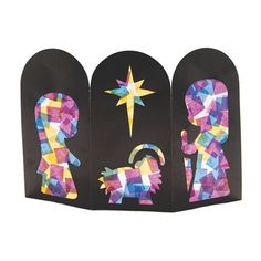 three paper cutouts depicting the nativity of jesus and mary, each with an ornament