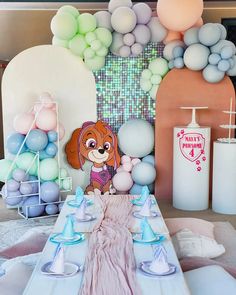 a table set up with balloons and decorations