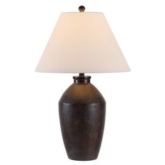 a table lamp with a white shade on it's base and a dark brown finish