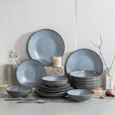 a table topped with lots of plates and bowls