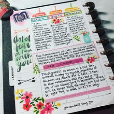 an open planner with flowers and writing on it