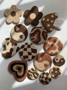 several knitted teddy bears are arranged on a white surface with shadows from the window