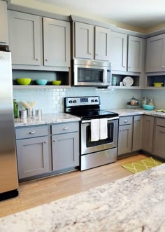 a kitchen with stainless steel appliances and granite counter tops