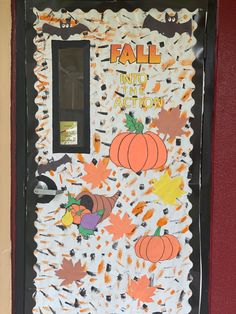 a door decorated with fall leaves and pumpkins