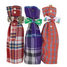 three different colored plaid bottles with bows on them