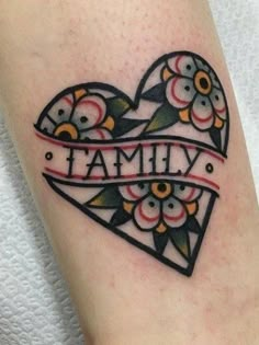 a tattoo on the leg of a woman with a heart and name written in it