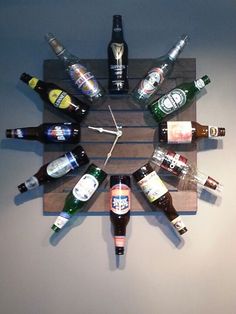 a clock made out of beer bottles on top of a wooden board that says it's beer o'clock somewhere this woman's husband used an old table to share more