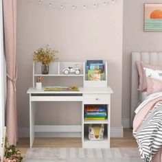 a bedroom with a bed, desk and bookshelf next to a pink wall