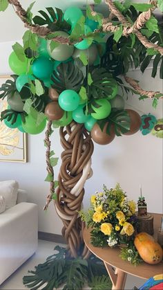 the balloon tree is decorated with green and brown balloons