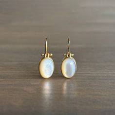 Mother of pearl shimmers sweetly at the end of buttery gold ear wires in this dreamy pair. 18k yellow gold Mother of pearl, 8.08ctw, 8mm x 11mm (5/16" x 1/2") Earrings hang 7/8" from the ear Each earring weighs 2g Cabochon Earrings, Mother Of Pearl Jewelry, Pearl Earrings Wedding, Mother Of Pearl Earrings, 2 Earrings, Newport Ri, Earrings Wedding, Bracelet Gift, Ear Wires