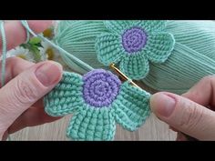 crochet flowers are being worked on by someone