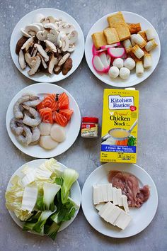 four white plates with different types of food on them and a carton of butter