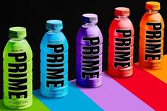 five different types of water bottles with the words drink me on them in rainbow colors