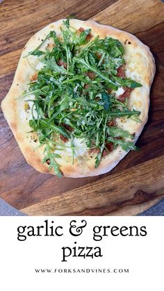 garlic and greens pizza on a cutting board with text overlay that reads garlic and greens pizza