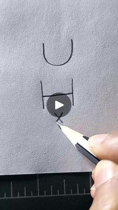 someone is drawing a face with a pencil