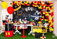 a mickey mouse birthday party with balloons and decorations