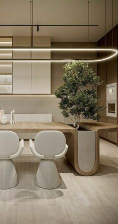 a modern kitchen with white chairs and an oval dining table in the center is lit by recessed lighting