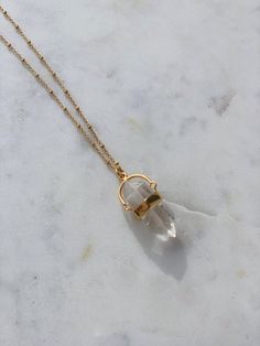 "A must have in your jewelry collection! Beautiful natural double terminated clear crystal quartz, a piece of jewelry that is also healing and supporting you every single day you wear it and keep close to you. Clear quartz is polished into the shape of a hexagonal prism, the prism is then plated in a strip of gold, which makes the necklace even more special when it comes to it's looks. Clear quartz is considered a \"master healer.\" It's said to amplify energy by absorbing, storing, releasing, a