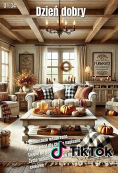 a living room filled with furniture and lots of pumpkins on the coffee table in front of a window