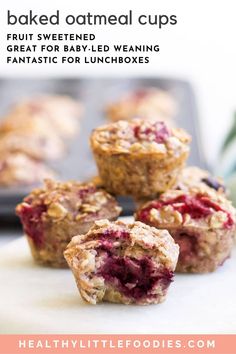 some muffins are sitting on top of a white board with other muffins in the background