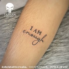 a tattoo saying i am enough on someone's arm