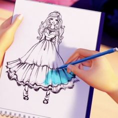 a drawing of a girl in a dress on a notebook with a pen and paper