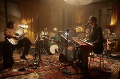 a group of people playing instruments in a room