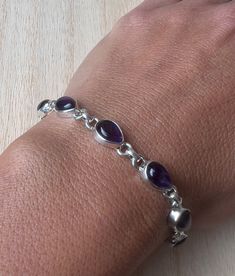 Lovely amethyst and sterling silver bracelet. The bracelet has 8 individual amethyst in an oval shape.  The bracelet measure 20 cm  long and it is almost 0.6 cm wide. The bracelet can be  easily  adjusted from 20 cm to 19 cm.  The high quality of our stones is what it makes this bracelet so precious.  A perfect present for her on any occasion St Valentine Day, Birthday, Anniversary, Travelling or Christmas. Amethyst Healing Properties ♥ Promote calm, balance and peace ♥  ♥ Eliminate impatience ♥ Purple Amethyst Birthstone Bracelet, Classic Amethyst Bracelets, Classic Silver Bracelets With Birthstone, Classic Silver Birthstone Bracelets, Classic Silver Bracelet With Birthstone, Silver Amethyst Teardrop Jewelry, Silver Teardrop Amethyst Jewelry, Classic Handmade Amethyst Jewelry, Classic Amethyst Bracelets In Purple