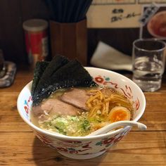 a bowl of ramen is sitting on a table