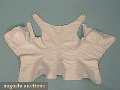 RARE WHITE LINEN CORSET, 1790-1810 Go Back      Lot: 651     October 2006 Vintage Clothing  Textile Auction     New Hope, PA  Fabric woven in herringbone pattern, front lacing w/ brass hooks, pair embroidered eyelets on each shoulder for tying, B 29", W 21", L 19", (lacings not original) excellent. Regency Corset, Linen Corset, French Inspired Fashion, Augusta Auctions, Brass Hooks