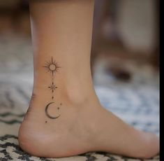 a woman's foot with a small tattoo on the side of her leg and a sun and moon