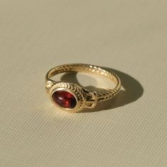 Ancient Heirloom Ring - Garnet – COMMON ERA Ceremonial Oval Cabochon Rings, Heirloom Style Yellow Gold Cabochon Jewelry, Heirloom Yellow Gold Cabochon Ruby Ring, Ceremonial 14k Gold Jewelry With Historical Design, Heirloom Ceremonial Gemstone Rings, Ceremonial Byzantine Jewelry With Cabochon, Heirloom Ruby Jewelry With Cabochon, Ceremonial Byzantine Cabochon Jewelry, Elegant Gold Garnet Cabochon Jewelry