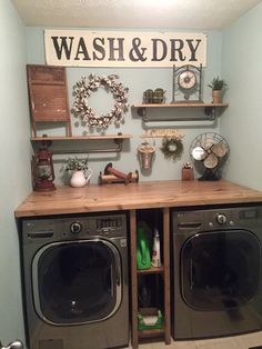 a washer and dryer sitting in a room next to each other with shelves on the wall