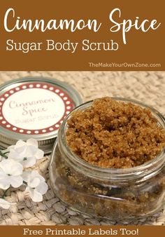 cinnamon spice sugar body scrub in a glass jar with flowers on the table next to it