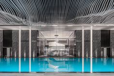 an indoor swimming pool with blue water