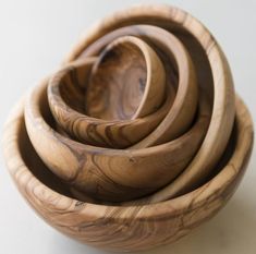 four wooden bowls stacked on top of each other