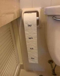 a roll of toilet paper hanging from the side of a bathroom wall next to a urinal