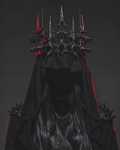 a woman with long black hair and spikes on her head is wearing a costume that has been made to look like a demon