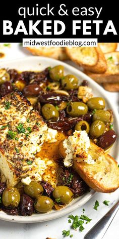 baked feta with olives on a white plate and bread in the background text reads baked feta with olives