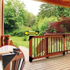 a wooden deck with chairs and table on top of it next to a wooded area