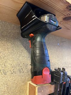 a cordless drill is sitting on top of a piece of wood