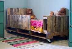 two teddy bears sitting on top of a bed in a child's room with blue walls