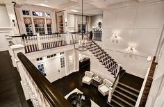 the stairs in this house are made of wood and have white railings that lead up to the second floor