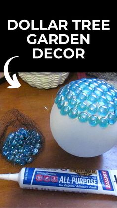 the dollar tree garden decor is next to a white ball with blue beads on it