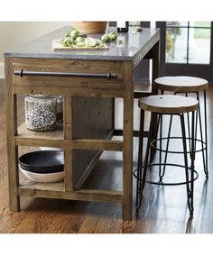 a kitchen island with two stools next to it